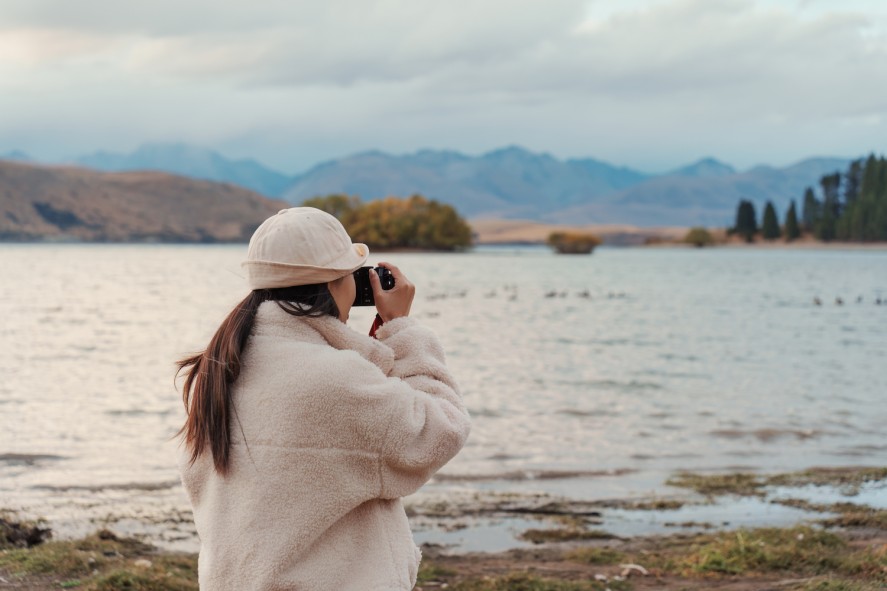 girl with camera at Lake Tekapo